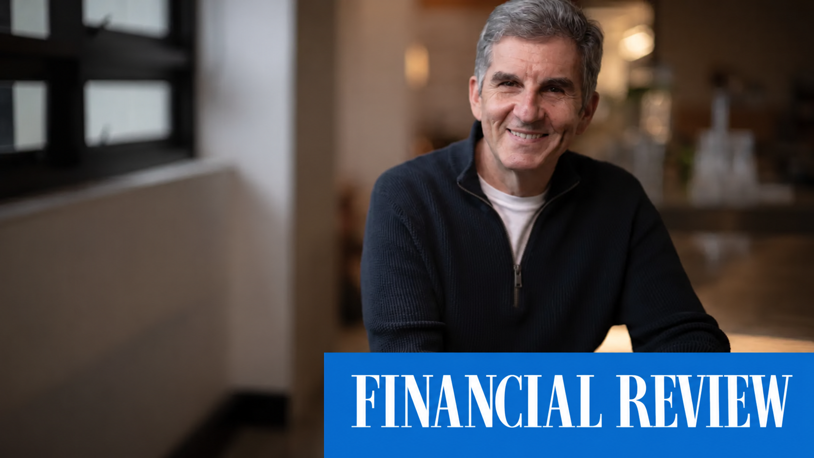 Daniel Petre seated indoors, with the Financial Review banner.